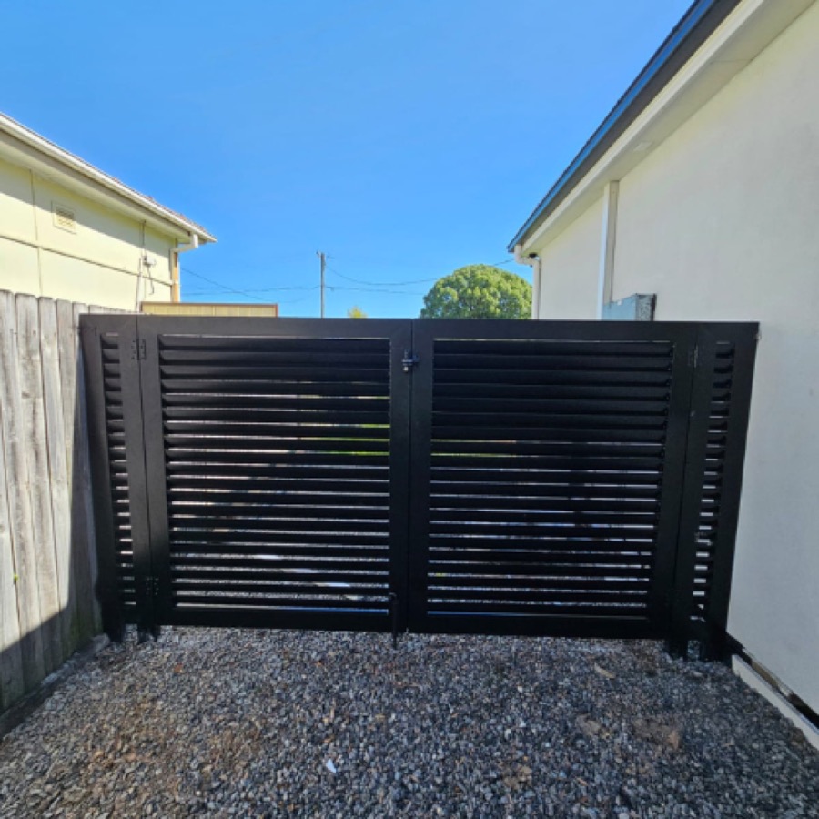 Black horizontal slat aluminium double gate on a residential driveway