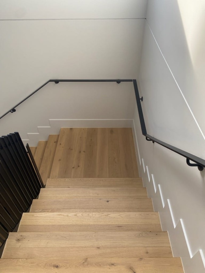 Black handrail and slat balustrade on internal timber stairs